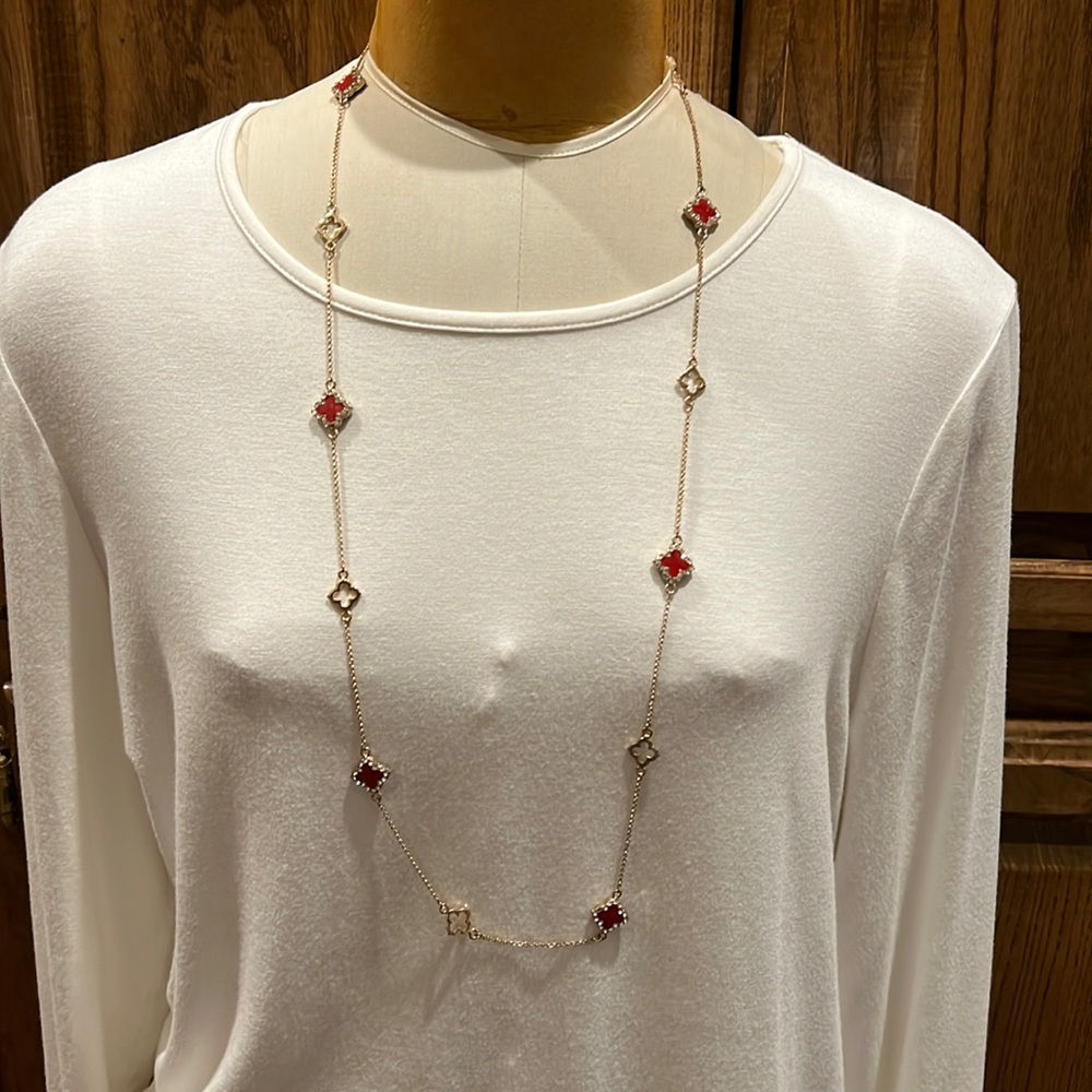 NWOT Gold necklace with red stones and clear rhinestones.